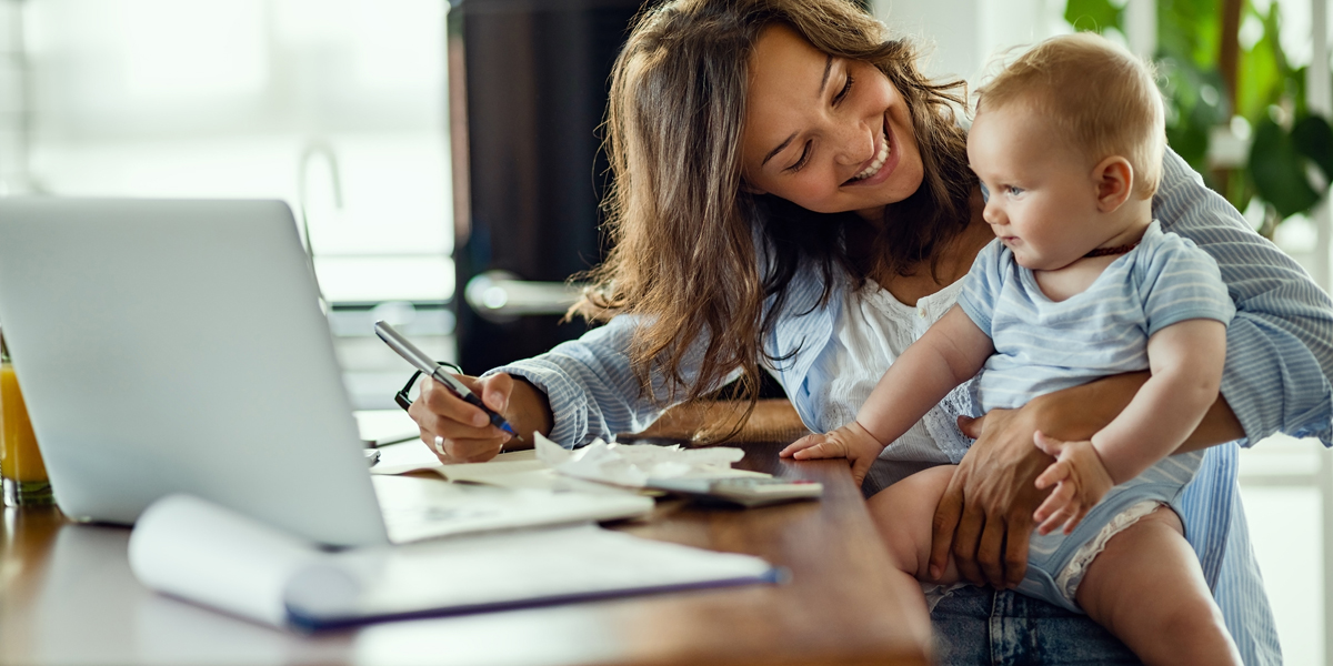 mom with baby doing her banking