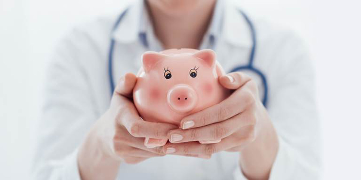 Health Care Professional holding piggy bank