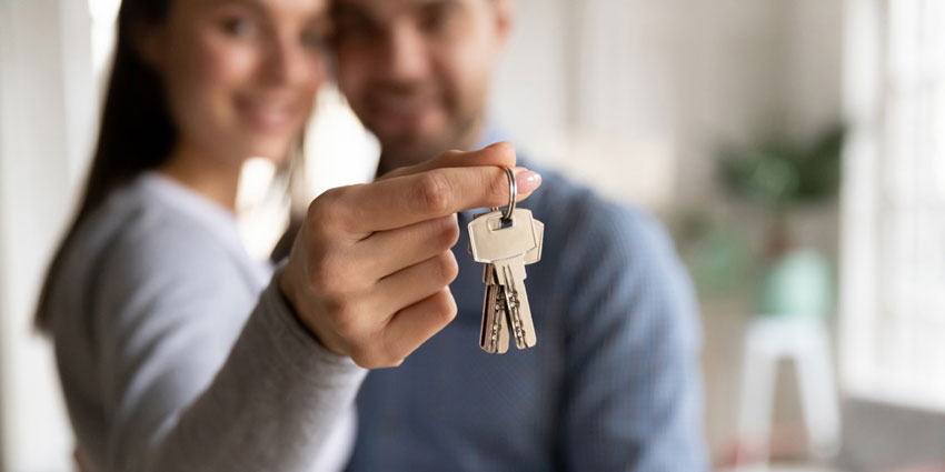 young couple holding keys