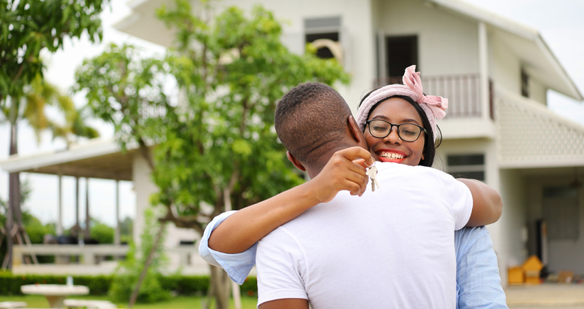 young happy couple holding keys