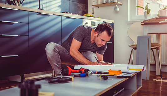 A man making improvements to his kitchen