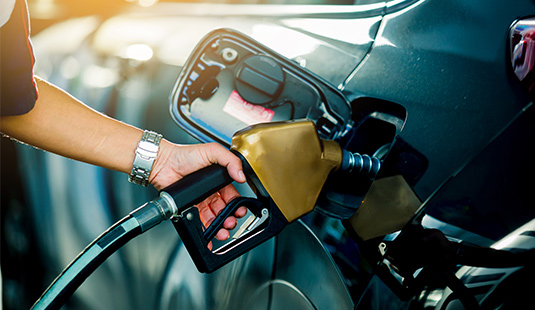 A person pumping gas